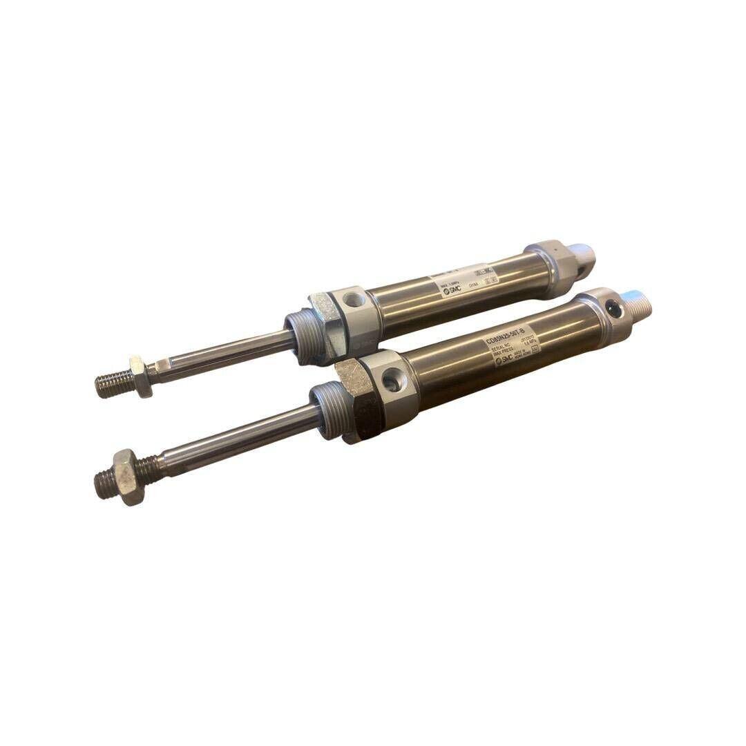 Pair of SMC pneumatic piston rod cylinders 25mm bore, silver metal, for industrial automation