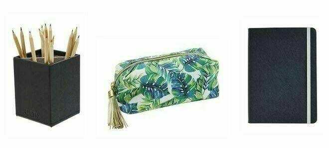 Black pencil holder with pencils, a green leaf print makeup or pencil pouch, and a closed black notebook