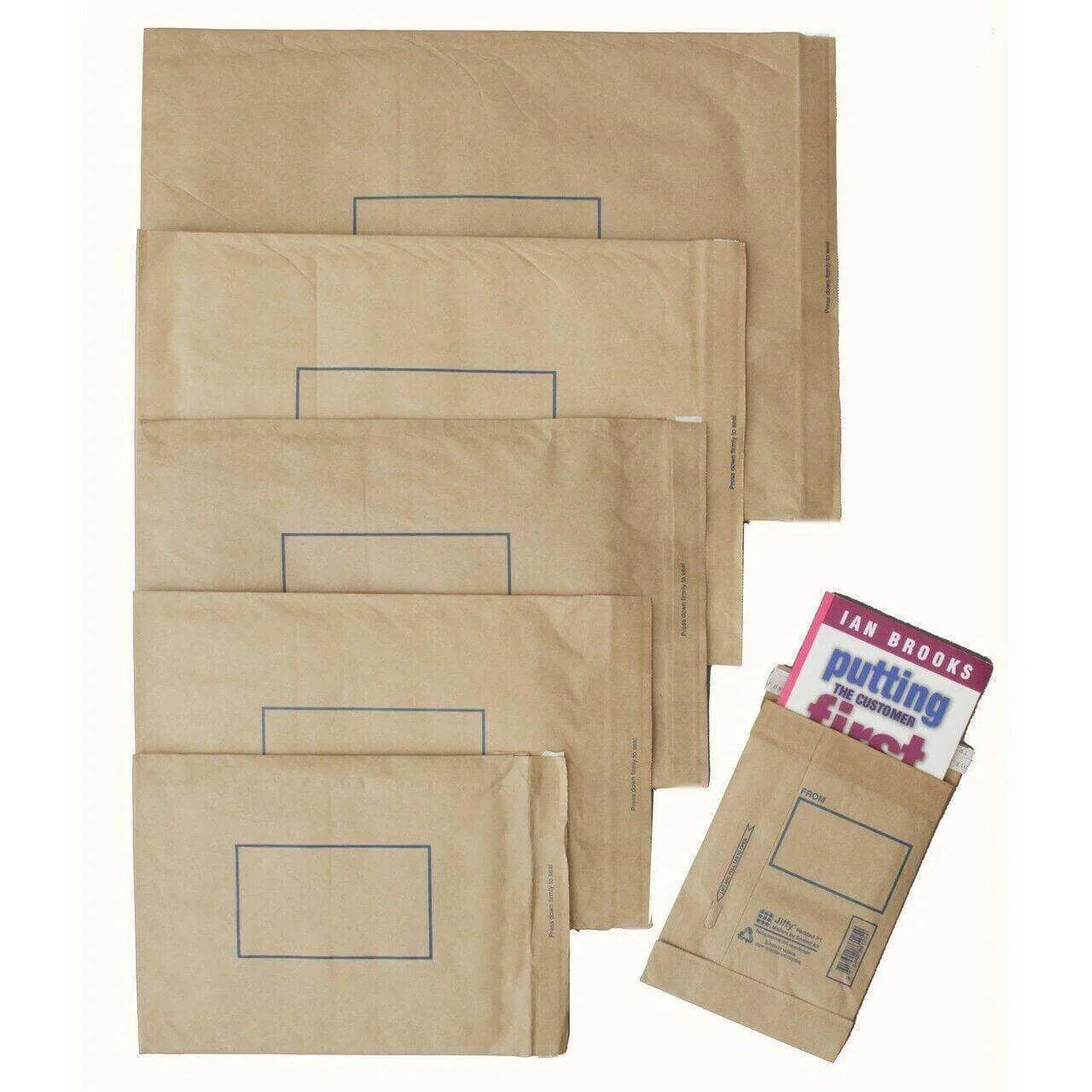 Assorted brown padded self-seal mailer bags, one with a book inside, on white background