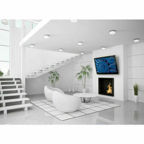 Heavy-duty flat TV wall mount holding large flat screen in modern living room with white decor