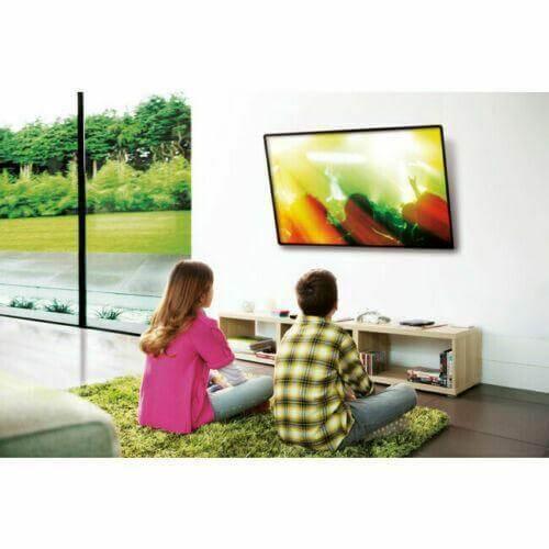 Flat TV wall mount holding large television in modern living room with two people watching