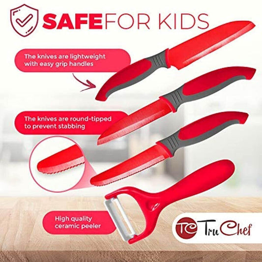 Red kids knife set with safe, round-tipped knives and ceramic peeler on kitchen counter.