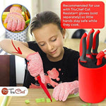 Child wearing cut-resistant gloves using red kids knife set to cut vegetables, knife block nearby