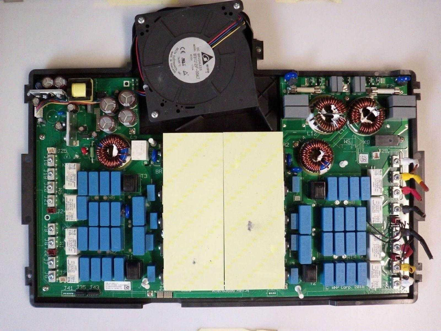 Electronic circuit board assembly with cooling fan, capacitors, relays, and wiring connectors