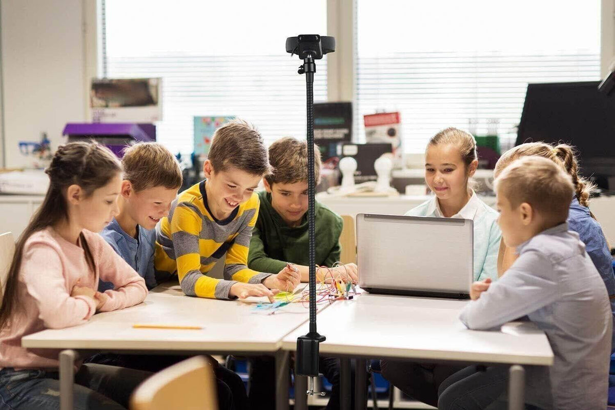 Kids learning electronics with laptop and circuit kit in classroom