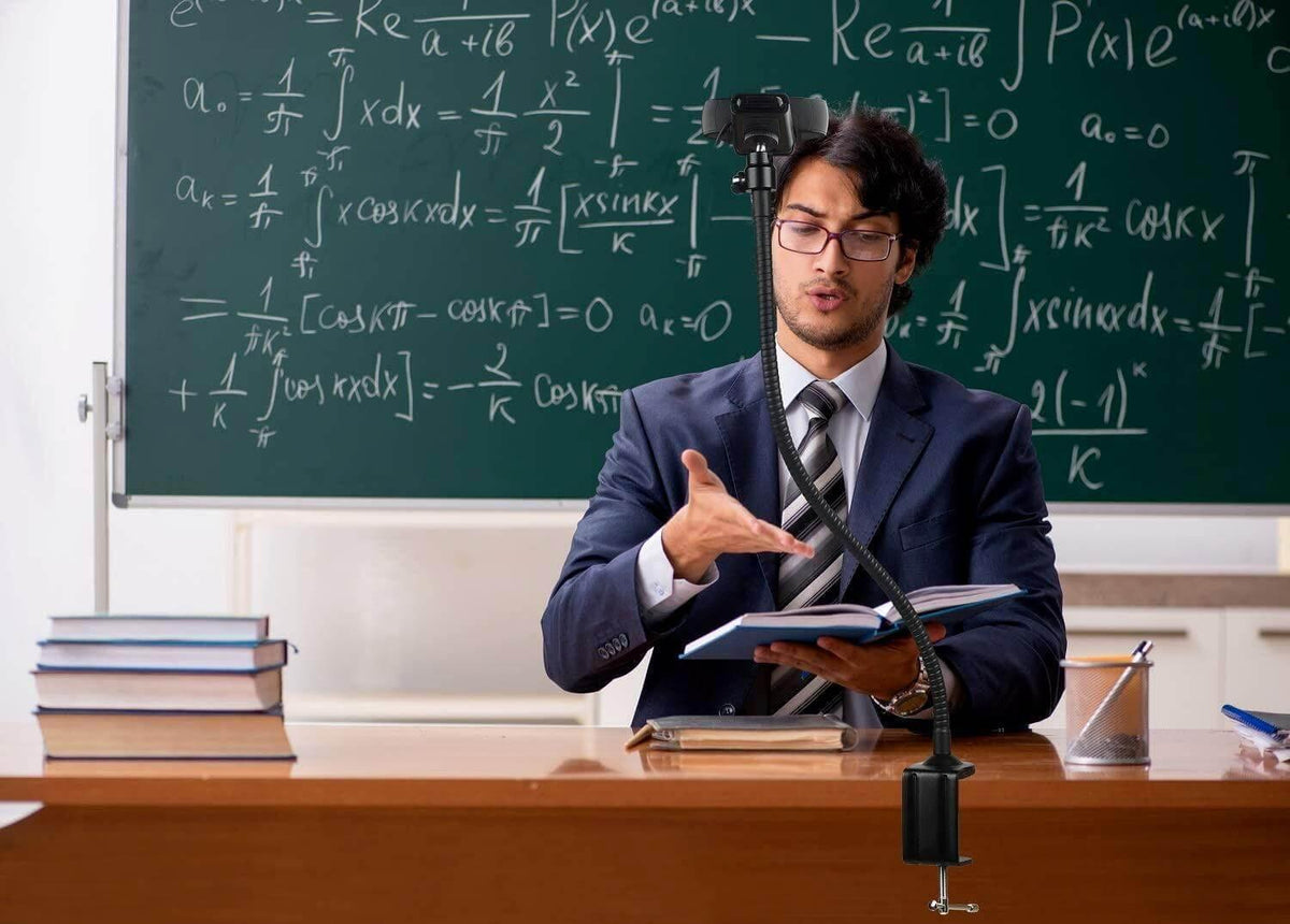 Man teaching math with flexible desk mount phone holder in classroom