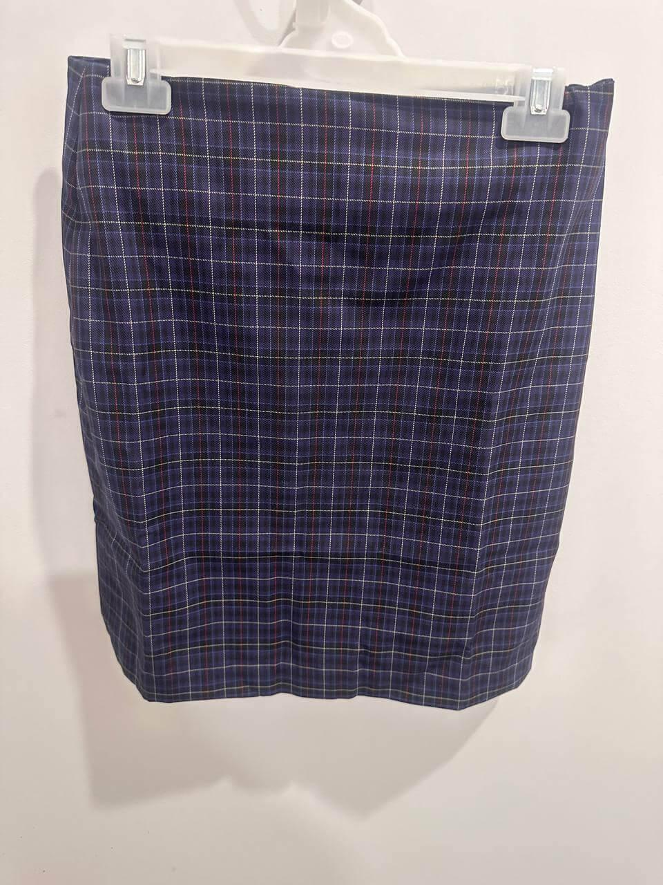 Blue plaid workwear skirt with white and red lines, hanging on display hanger