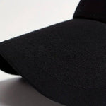 Black baseball cap with textured fabric and curved brim