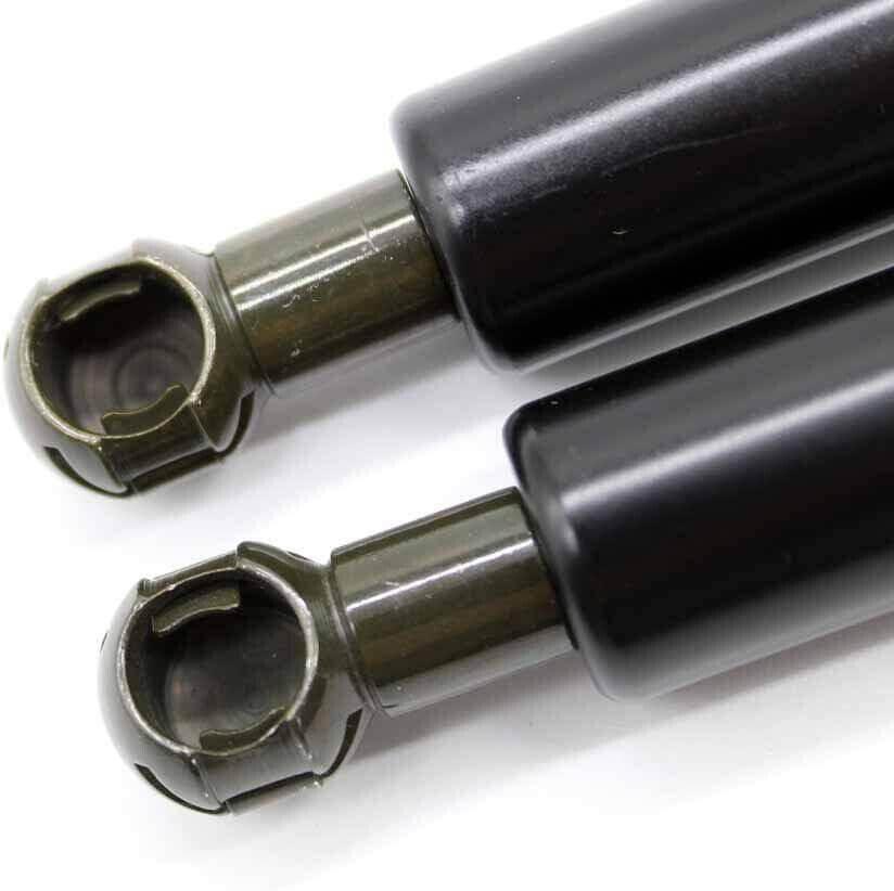 Black shock absorbers with metal ends for tractor or truck parts