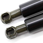 Black shock absorbers with metal ends for tractor or truck parts