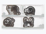 Assorted steel E-clips shaped like cats for office paper organization, displayed in a tray
