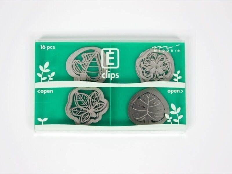 Set of 16 decorative steel paper clips in nature-inspired shapes in a green case
