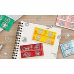 Assorted silver metal E-clips in various shapes on a spiral notebook and desk