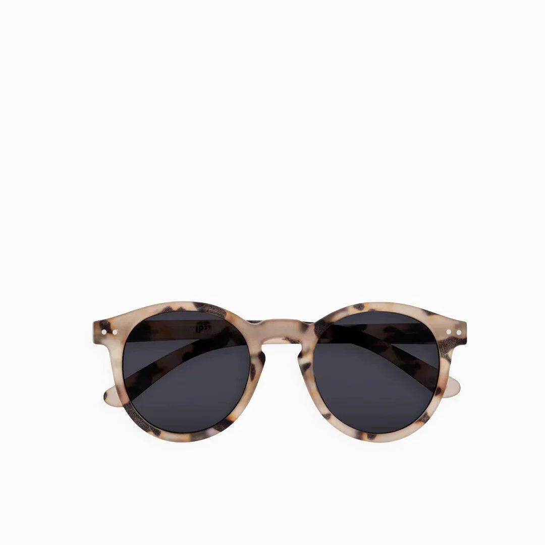Tortoiseshell round sunglasses with dark lenses, stylish and modern design