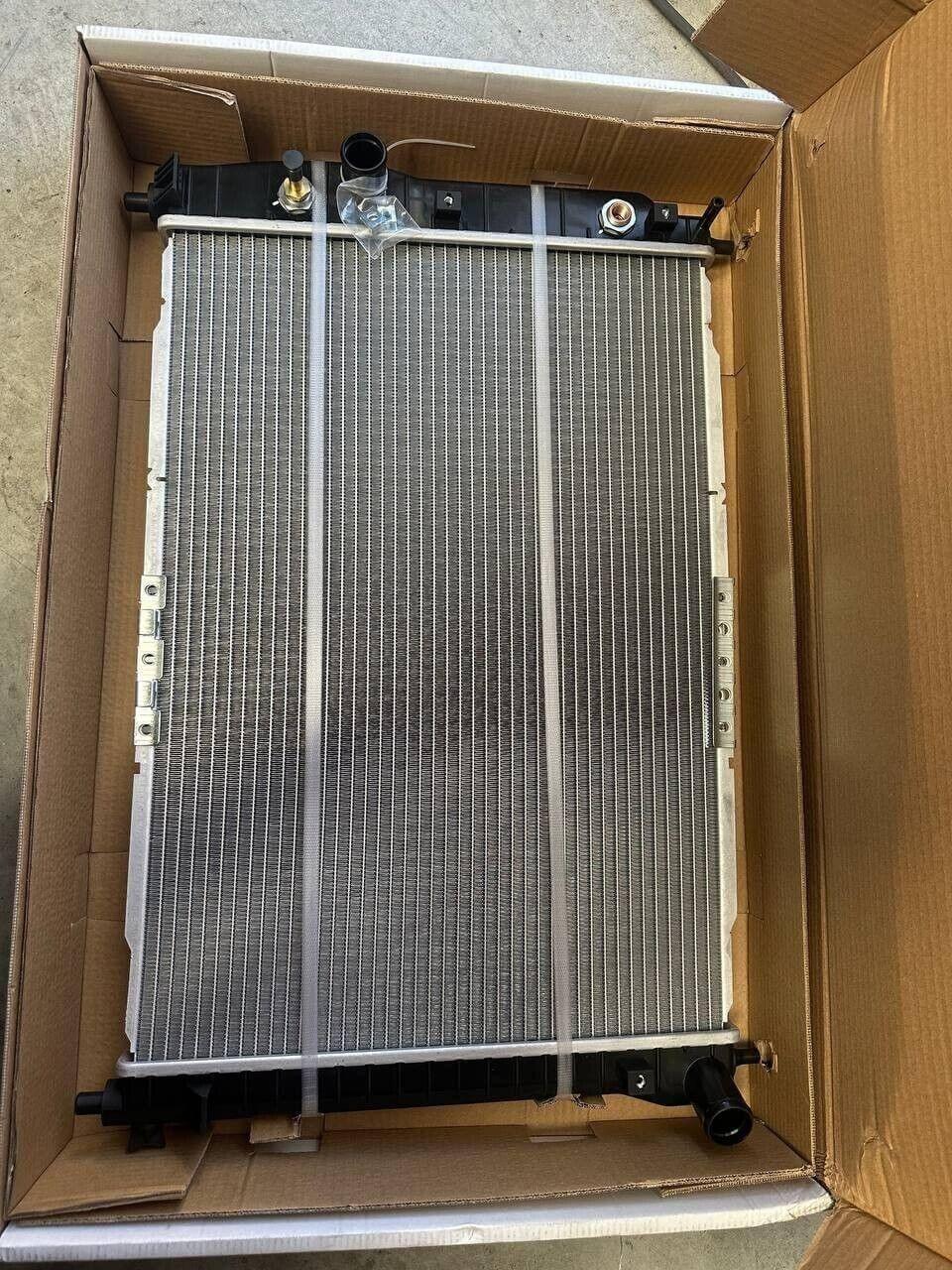 New tractor radiator in box, compatible with AGCO and EATON parts, ideal for international truck repairs.