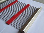 Metal grate with red plastic strips and stainless steel edge for industrial use