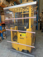 Yellow forklift FW-974 behind safety string barrier in warehouse with shelving and boxes