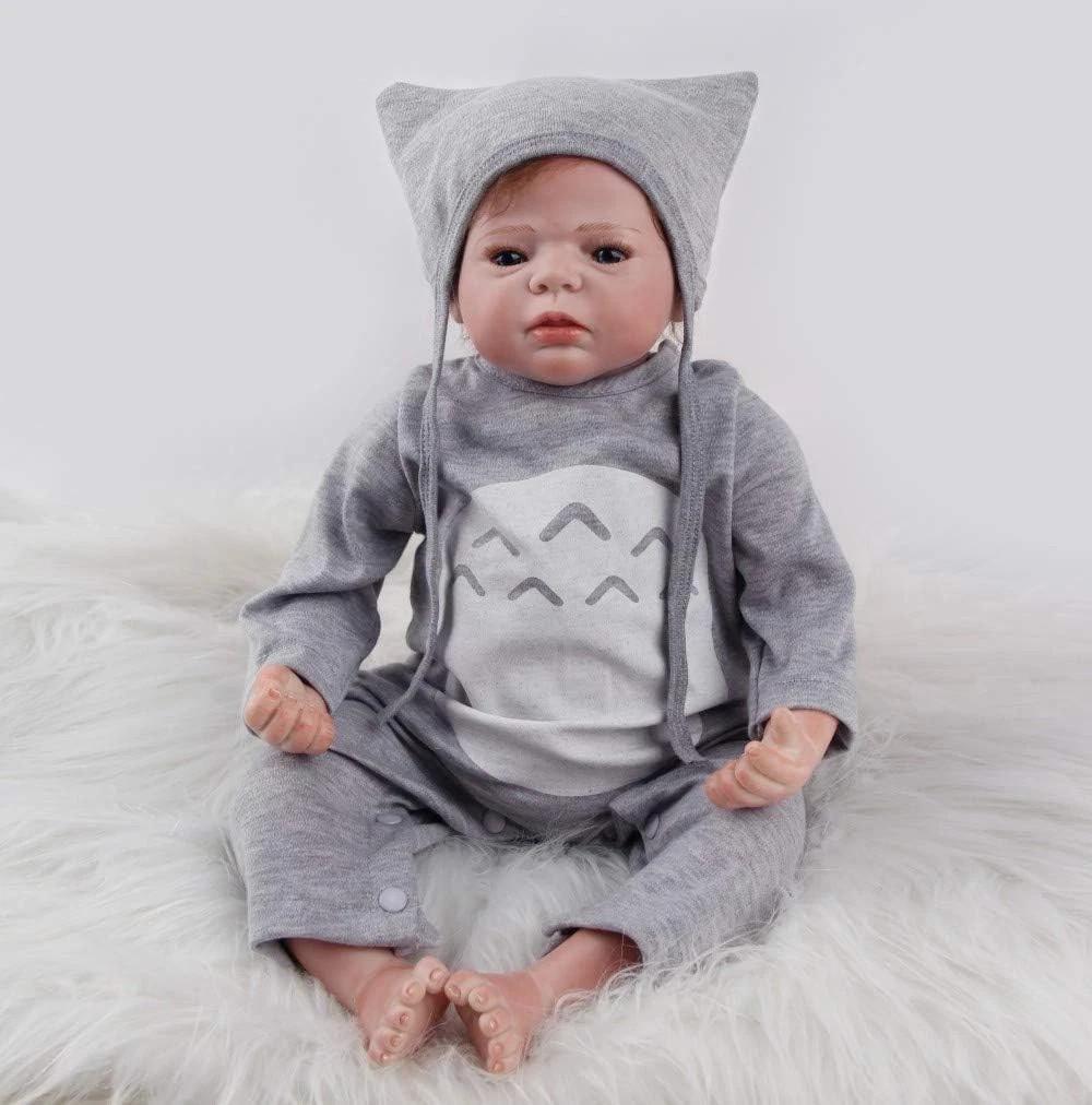 Realistic baby doll in gray cat-themed outfit on fluffy white rug