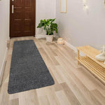 Gray shaggy hallway runner rug on wood floor, modern entryway decor with plant and bench