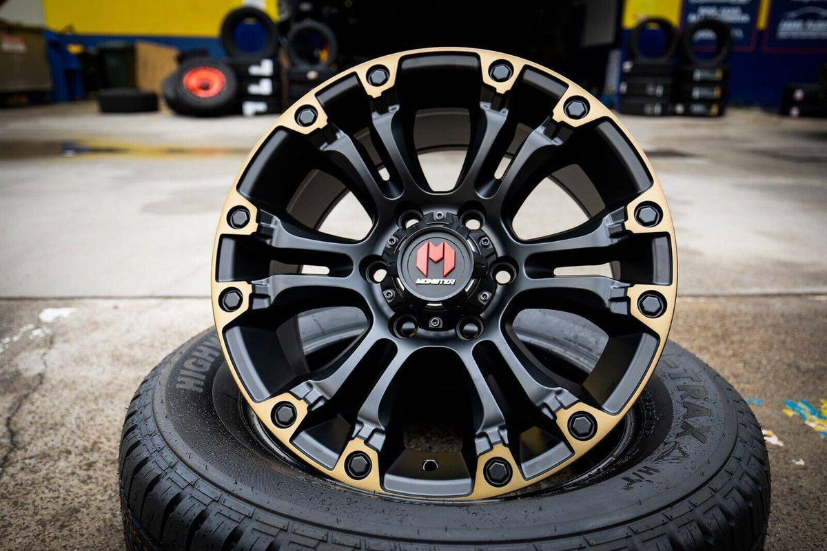 Black and gold Monster wheel rim on tire, rugged off-road design