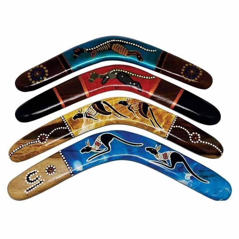 Hand-painted boomerangs with Aboriginal art designs featuring kangaroos and dot patterns
