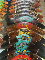 Hand-painted wooden boomerangs with Aboriginal art designs, featuring animals and dot patterns.