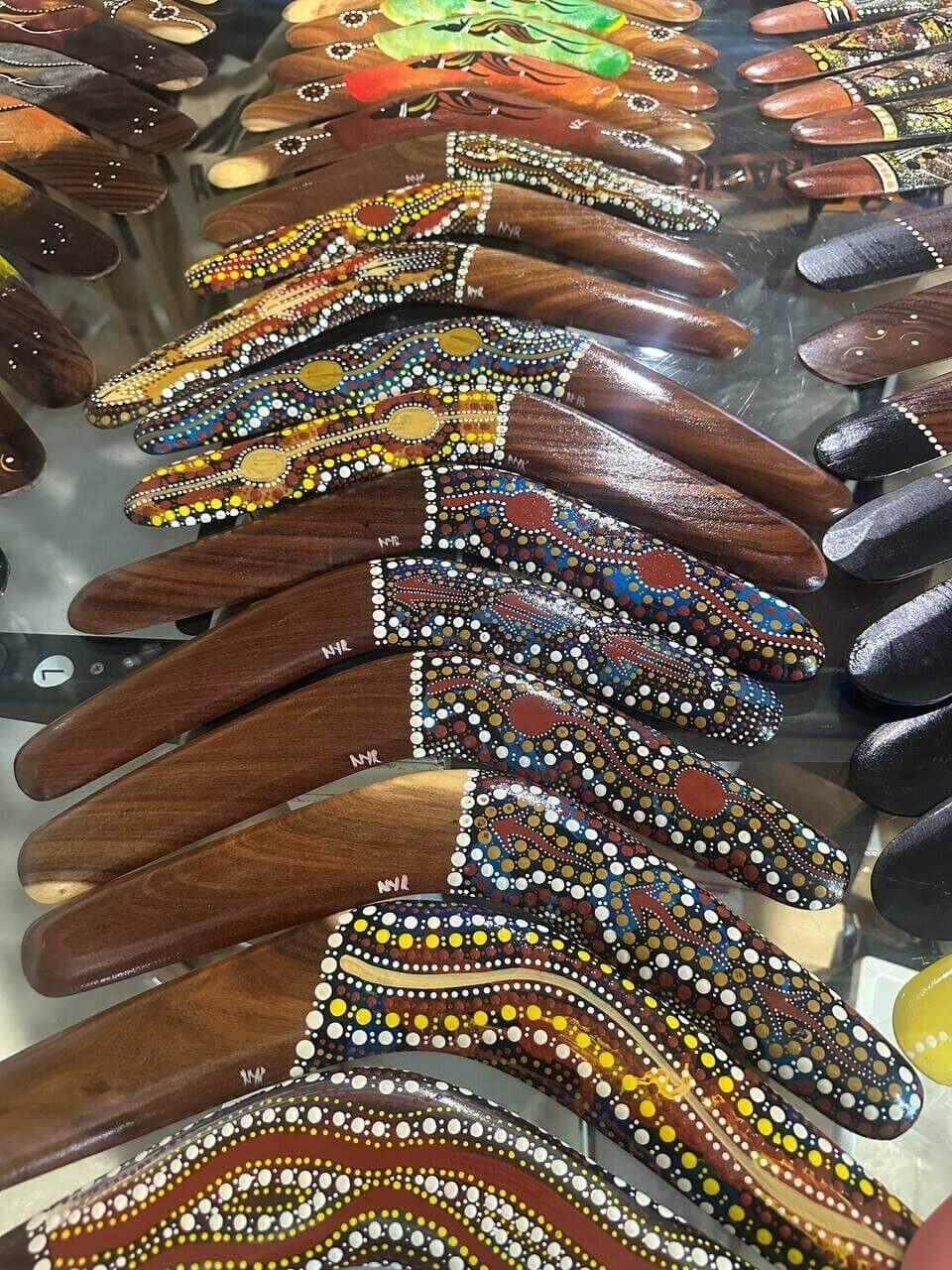 Colorful hand-painted boomerangs with Aboriginal dot art, wooden craftsmanship, decorative collectibles