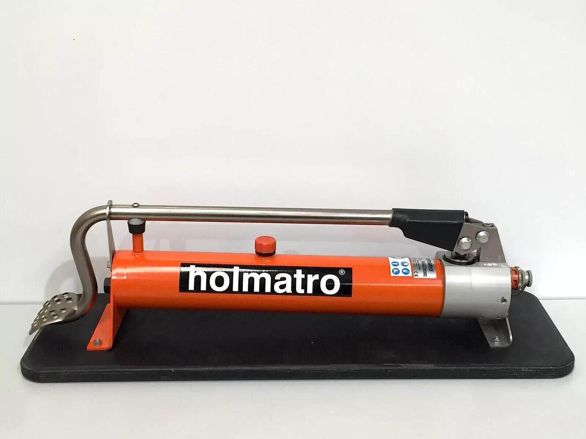 Holmatro hydraulic hand pump with orange body and black base for industrial use