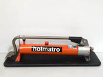 Holmatro hydraulic hand pump with orange body and black base for industrial use