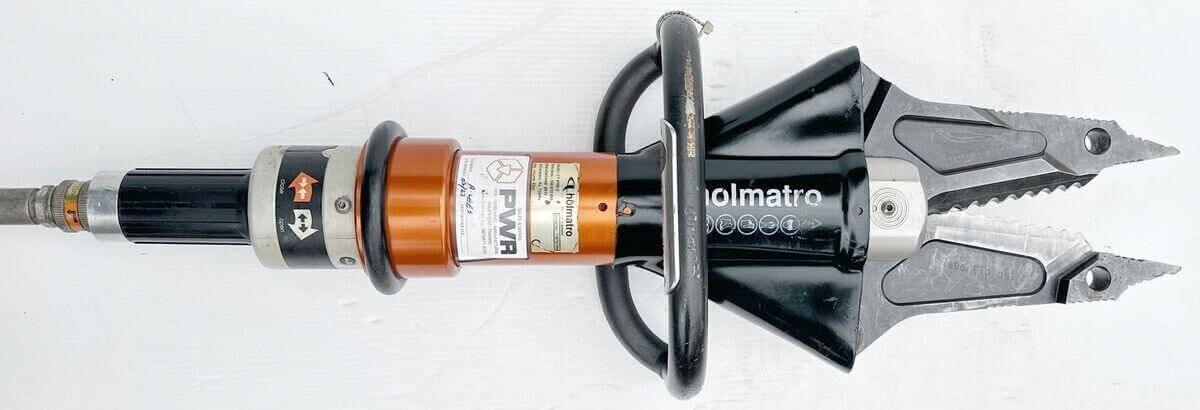 Holmatro PWR hydraulic rescue tool with cutting jaws, used for emergency vehicle extrication and heavy-duty rescue operations.