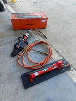 Holmatro hydraulic rescue tools with orange hoses and Power Pak case for emergency vehicle extrication