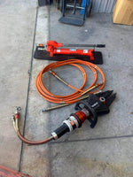 Holmatro hydraulic rescue tools with orange hoses, ideal for auto repair and emergency services