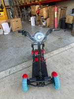Red and black electric scooter with blue wheels in warehouse setting