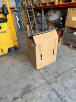 Large cardboard box with arrows in warehouse near forklift and storage shelves