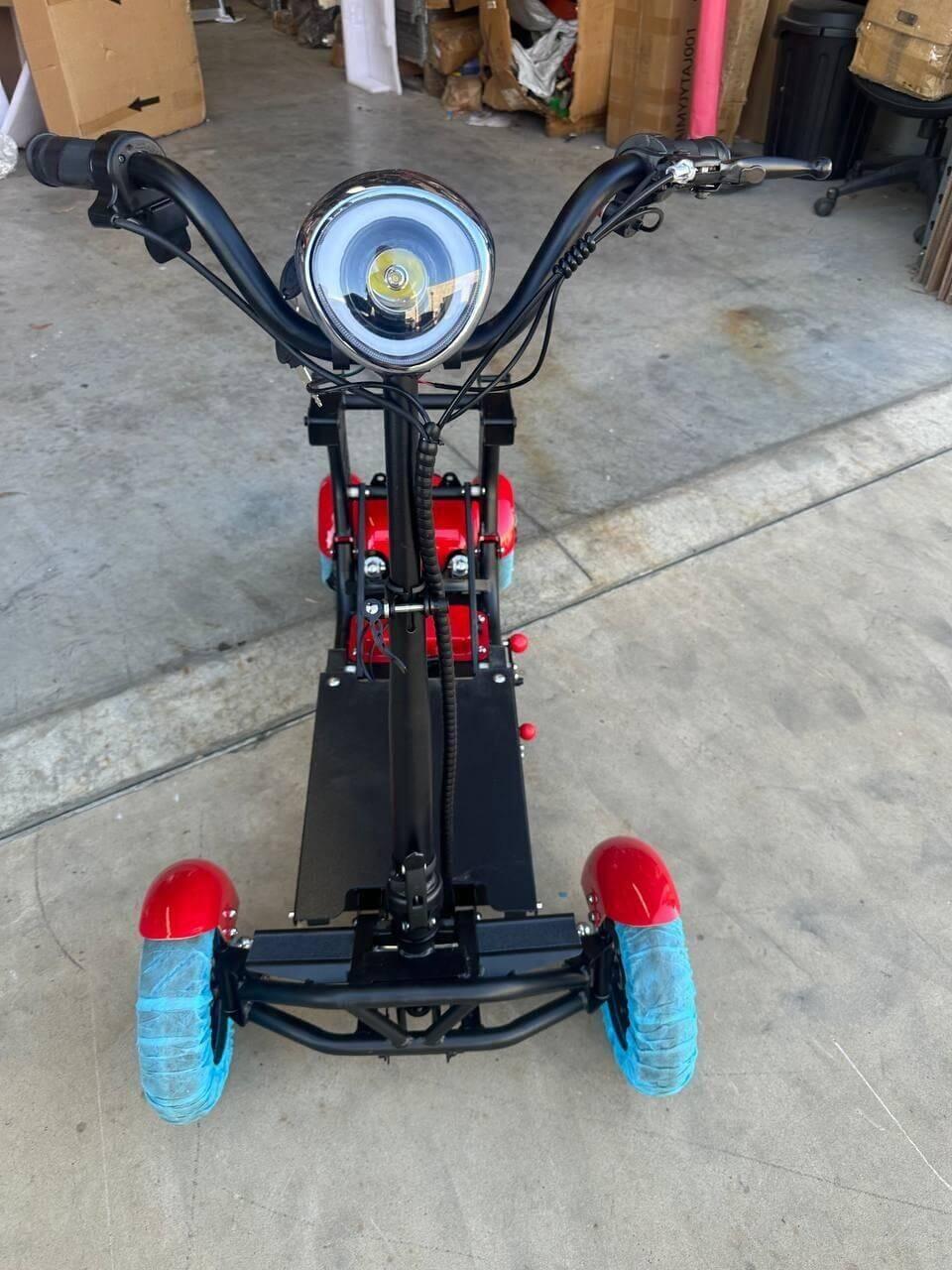 Red and blue electric scooter with bright headlight, ideal for urban commuting and outdoor adventures.
