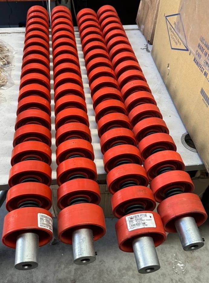 Red tractor suspension components with metal shafts, ideal for AGCO and EATON parts