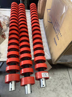 Red industrial spring-loaded rollers for conveyor systems, warehouse equipment parts