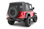 Red Jeep Wrangler with black soft top, off-road tires, and rear bumper, ideal for rugged terrain adventures.