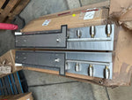 Industrial metal manifolds with valves for tractor or truck parts, warehouse setting