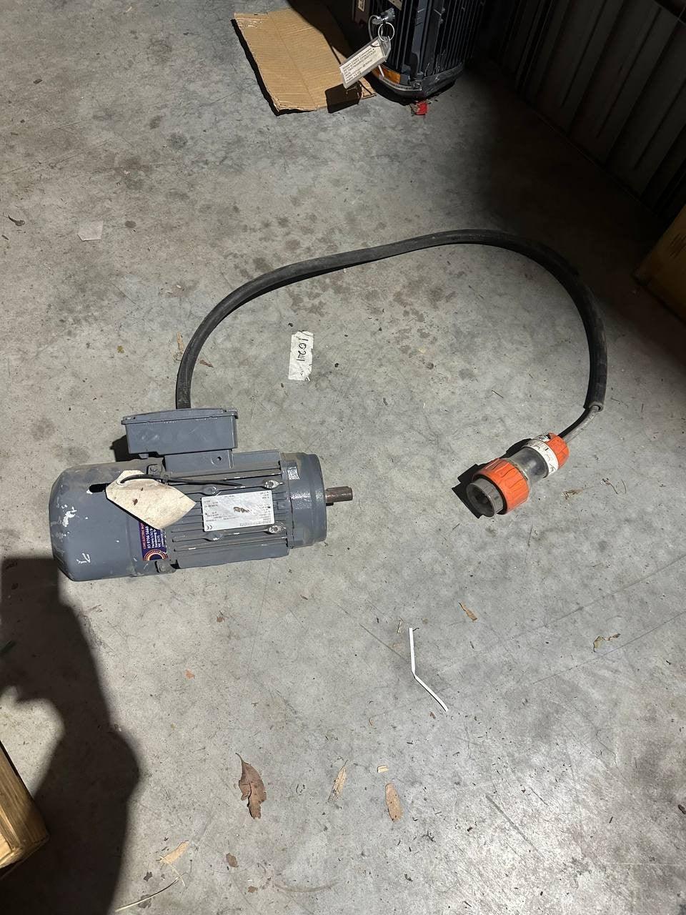 Industrial electric motor with orange plug, suitable for tractor parts and machinery use.