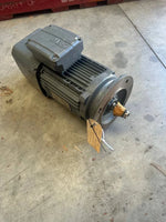 Industrial electric motor with tag, suitable for tractor or truck parts, warehouse setting