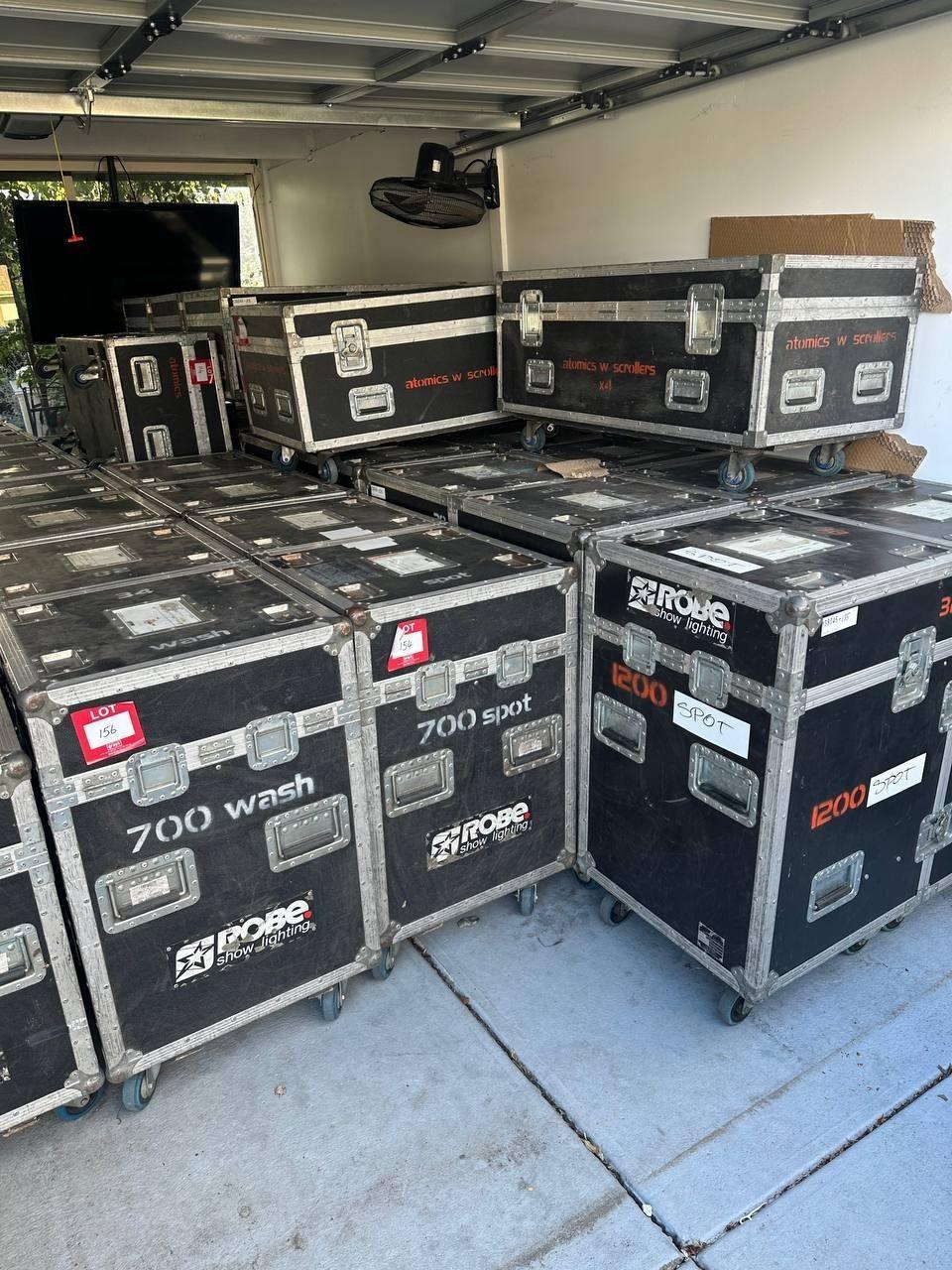 ROBE show lighting equipment cases labeled 700 wash, 700 spot, 1200 spot, stacked in truck