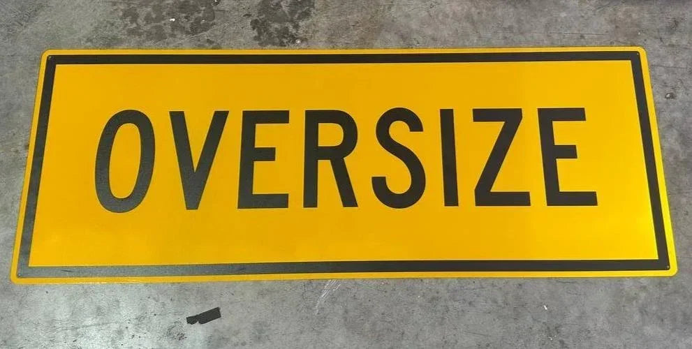 Yellow oversize warning sign for trucks and heavy equipment transport