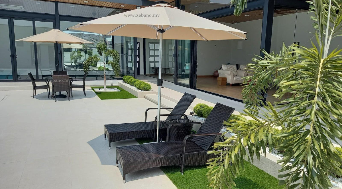 Outdoor patio with wicker lounge chairs, beige umbrellas, and greenery near modern glass doors