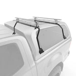 Black roof rack installed on white pickup truck for cargo storage
