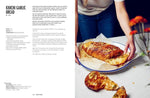 Kimchi garlic bread recipe with melted cheese, served on white plate with blue rim, hands tearing slice