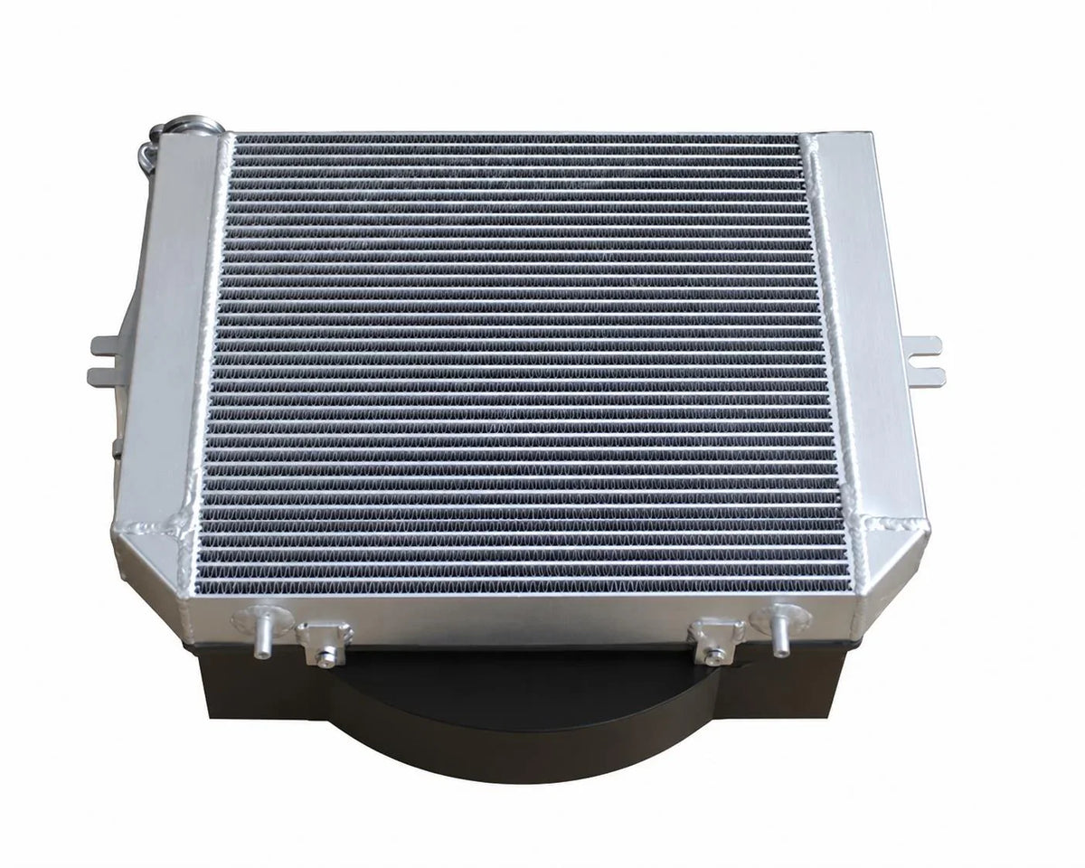 Aluminum intercooler for tractor or truck engine cooling system, heavy-duty design with finned core and mounting tabs