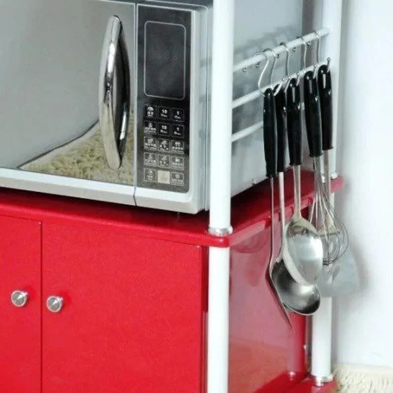 Red kitchen storage cabinet with microwave and hanging utensils for organized cooking space