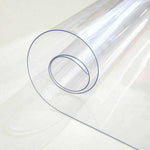 Clear PVC tablecloth roll, transparent plastic table cover protector on white surface