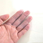 Clear PVC plastic table cover held by hand, showing its transparent protective finish